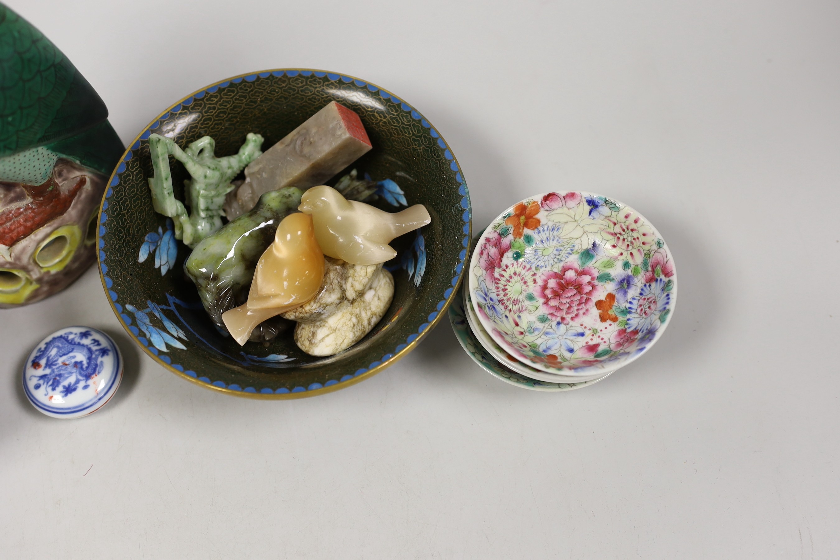 A group of Chinese hardstone carvings, a cloisonné enamel bowl, famille rose dishes and four blue and white bowls and model bird. Tallest 23cm